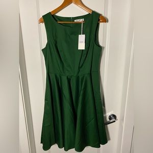 Forest green, boat neck dress, flares at waist.